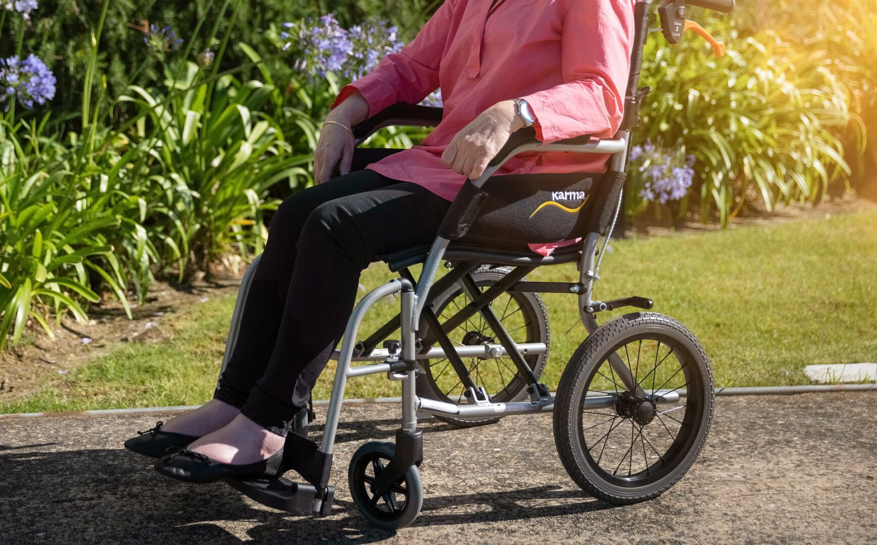 A person in a wheelchair sitting on the ground.